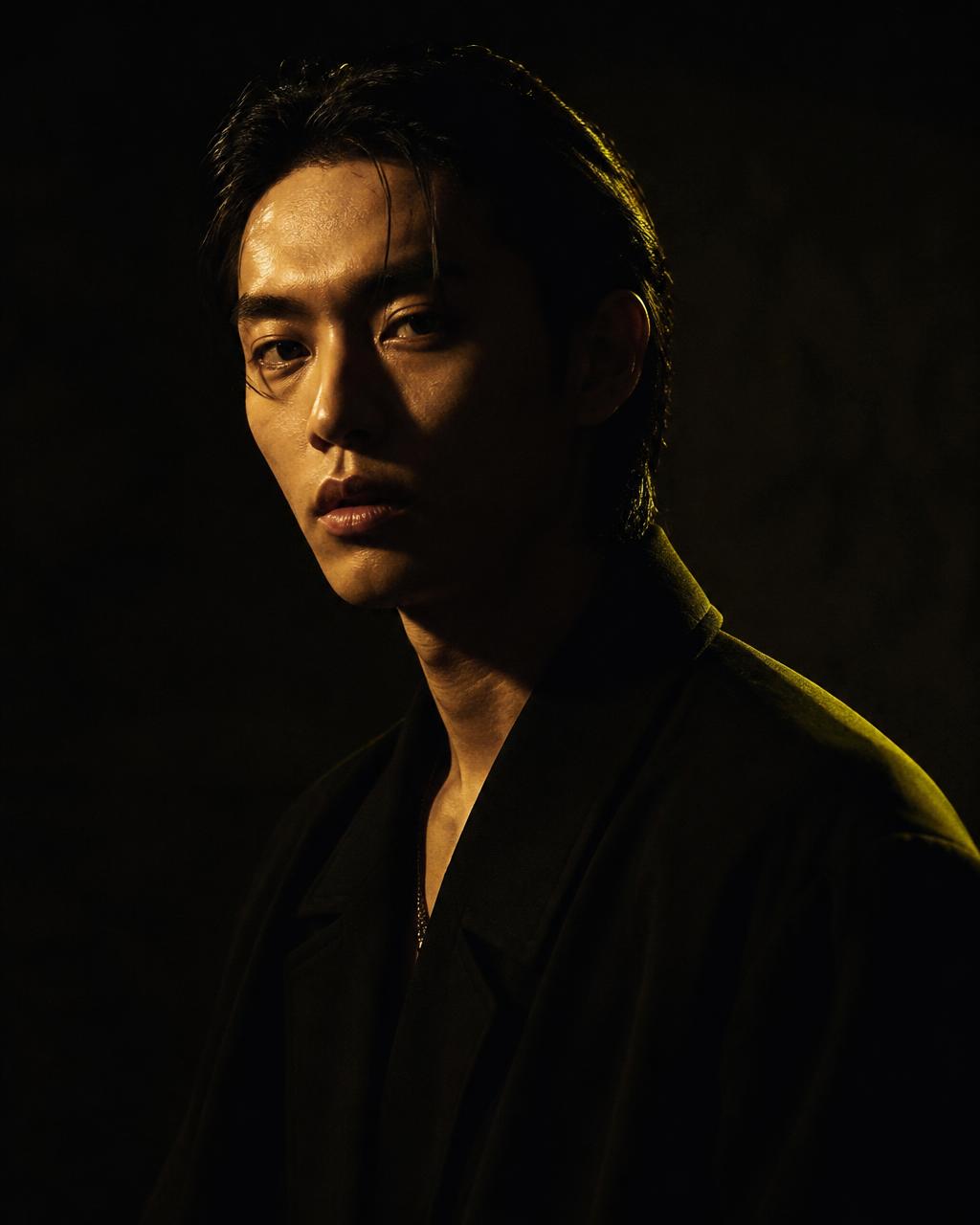 Studio portrait lit by a single hard key light